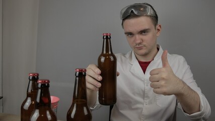 young master technologist brews beer at home, pours beer into bottles, checks the sugar level in beer, checks the percentage of alcohol in beer, checks the quality of the brewed