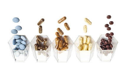 Medical capsules spilled out of a glass hexagonal jars