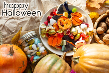 candy bowl of chocolates and sweets, Halloween Jack o Lantern cookies - fresh halloween pumpkin, gourd, squash Trick or Treat Halloween card background