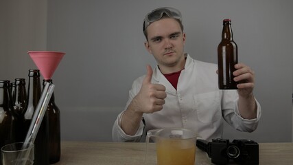 young master technologist brews beer at home, pours beer into bottles, checks the sugar level in beer, checks the percentage of alcohol in beer, checks the quality of the brewed