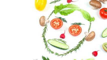 Funny face from different vegetables tomatoes, cucumber, radish, dill and rosemary isolated on white background. Healthy eating and vegan food concept. Kitchen
