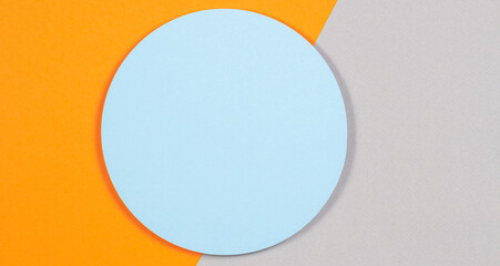Abstract geometric texture background of soft light blue, pastel gray and orange color paper. Top view, flat lay
