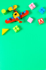 Obraz premium Set of colorful children toys on light green background. Top view, flat lay