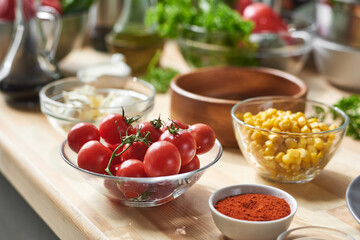 Close-up of fresh vegetables in bowl on the table with other ingredients preparing for cooking