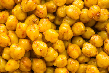 Cooking chickpeas with spices in a pan, close-up