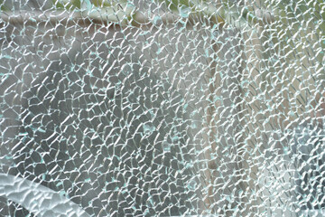Broken tempered glass. Cracked glass texture close up