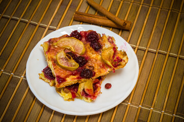 Homemade cookies with fruit in a white saucer on a bamboo mat