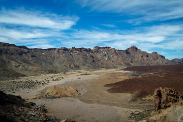 Rock mountains surrounding a valley with blue sky in Mount Teide