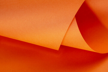Abstract bright orange paper background for your design. Three-dimensional geometric image. Selected sharpness.