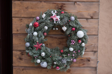 Beautiful Christmas wreath made of fir and Christmas toys on wooden