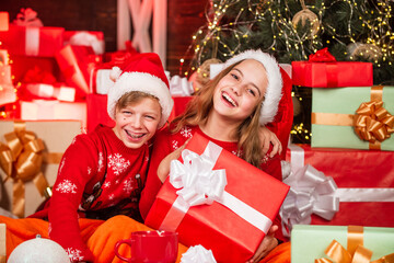 Obraz na płótnie Canvas Fun in motion. family values for children. cosy winter evening together. small kids friends have fun. santa helpers among red present. too much gift. online shopping. childhood happiness and carefree