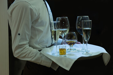 Waiter with a tray on which different alcohol