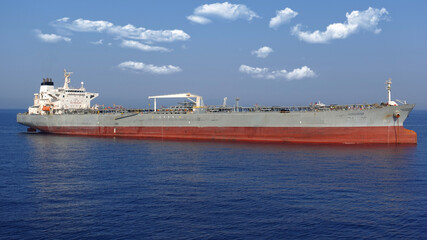 Zoom detail photo of industrial fuel and oil tanker ship anchored in Mediterranean deep blue sea