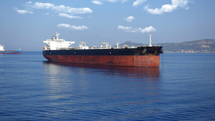 Zoom detail photo of industrial fuel and oil tanker ship anchored in Mediterranean deep blue sea