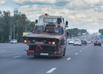 Fototapeta na wymiar Tow Truck Carries a broken tow truck