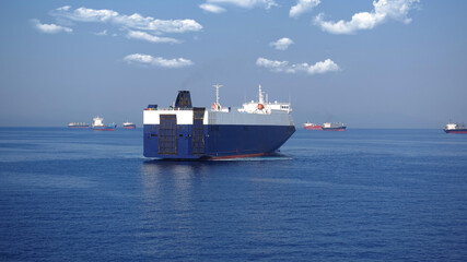 Huge car carrier ship RO-RO (Roll on Roll off) cruising in Mediterranean deep blue Aegean sea