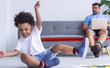 African boy playing in living room at home