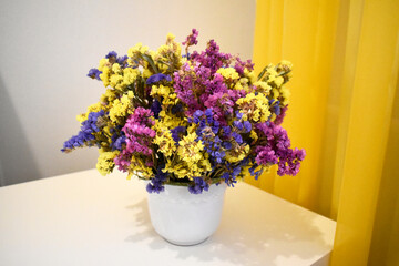 Beautiful bouquet of dried flowers in a white vase