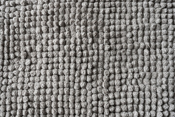 Texture of a gray blanket made of small balls.