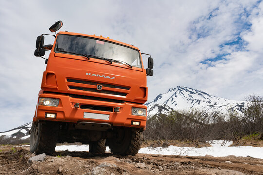 Russian off-road passenger expedition truck KamAZ on mountain road in direction popular travel destinations for mountain climbing on volcano. Kamchatka Peninsula, Russian Far East - June 20, 2020