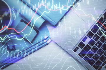 Double exposure of forex graph drawing over desktop background with computer. Concept of financial analysis. Top view.