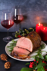 Roasted beef and red wine. Christmas decorations. New Year dinner table. View from above, top studio shot