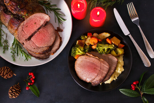 Roasted beef. Christmas decorations. New Year dinner table. View from above, top studio shot