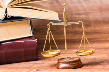 Law concept - Open law book with a wooden judges gavel on table in a courtroom or law enforcement office isolated on white background. Copy space for text