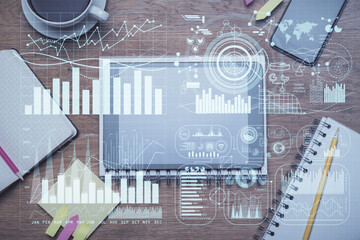 Double exposure of forex chart hologram over desktop with phone. Top view. Mobile trade platform concept.