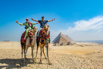 camel ride in the desert - obrazy, fototapety, plakaty
