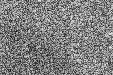 Black color styrofoam texture background. Close-up macro view of abstract plastic material pattern.