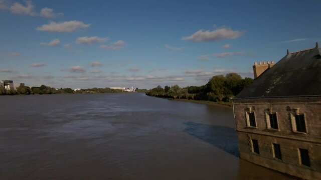House in river aerial fly pass