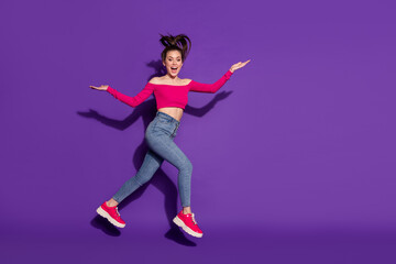 Fototapeta na wymiar Full length body size view of pretty carefree slender cheerful girl jumping running isolated over bright violet color background