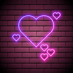 Neon glowing heart on the brick wall background . One big heart and small hearts around .