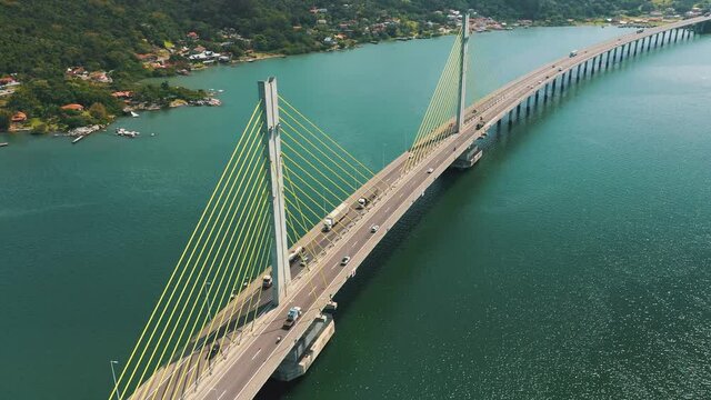 Amazing establishing aerial shot along Anita Garibaldi bridge above the ocean, located in Laguna, Santa Catarina, Brazil