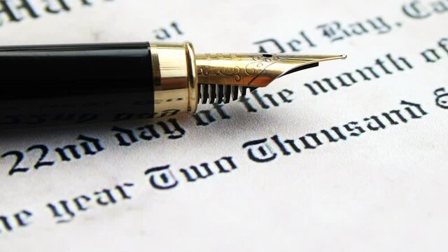 Fountain pen on marriage certificate dolly shot