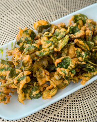 Vegetable fried tempura of "bayam brazil " or Brazillian Spinach, Poor Man Spinach. Healthy snack served on a plate.