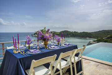 Fototapeta premium Purple and Gold Romantic Wedding Table Top Layout Table Spread no people no human tropical location copy space sea view trees and jungle ocean