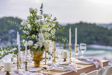 White and Gold Romantic Wedding Table Top Layout Table Spread no people no human tropical location with gold cutlery and scenic view tablescape