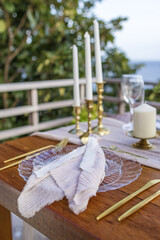 White and Gold Romantic Wedding Table Top Layout Table Spread no people no human tropical location with gold cutlery and scenic view tablescape