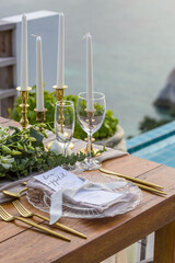 Romantic Wedding Table Top Layout Table Spread no people tropical location with gold cutlery and scenic view of sunset with copy space
