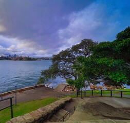 Fototapeta na wymiar Beautiful colours of Sydney Harbour viewed from Botanical Gardens in NSW Australia on cloudy spring afternoon