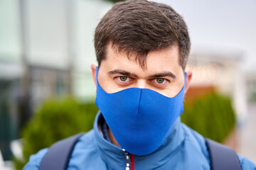 Male tourist walks in facial mask during pandemic covid-19.
