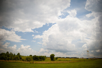 Fototapeta na wymiar Cloudy sky above a farm field