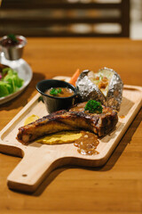 T-bone steak serve with mashed potatoes.