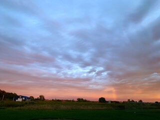 Pink and Blue Sunset over wooded field