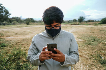 man using his phone in the park