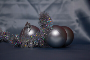 Christmas silver balls with tinsel on a silver background
