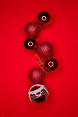 Christmas red balls stacked in a chain on a red background