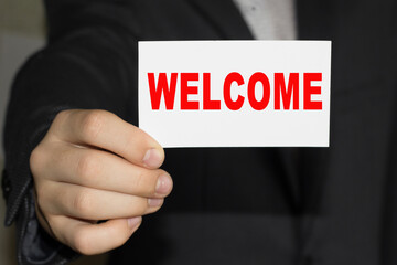 Card with text WELCOM on hand. You can use in business, marketing and other concepts.